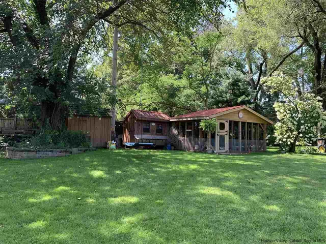 a white house in middle of the forest