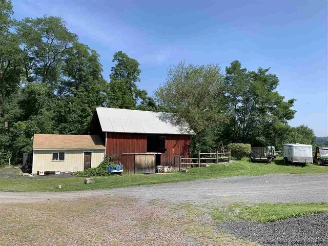a front view of a house with a yard and a garage