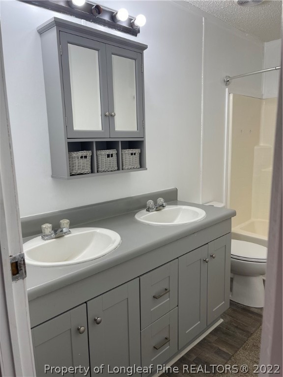 3915 Alamac Road Lumberton, NC 28358 - Photo 18 of 18 a bathroom with a sink a toilet and mirror