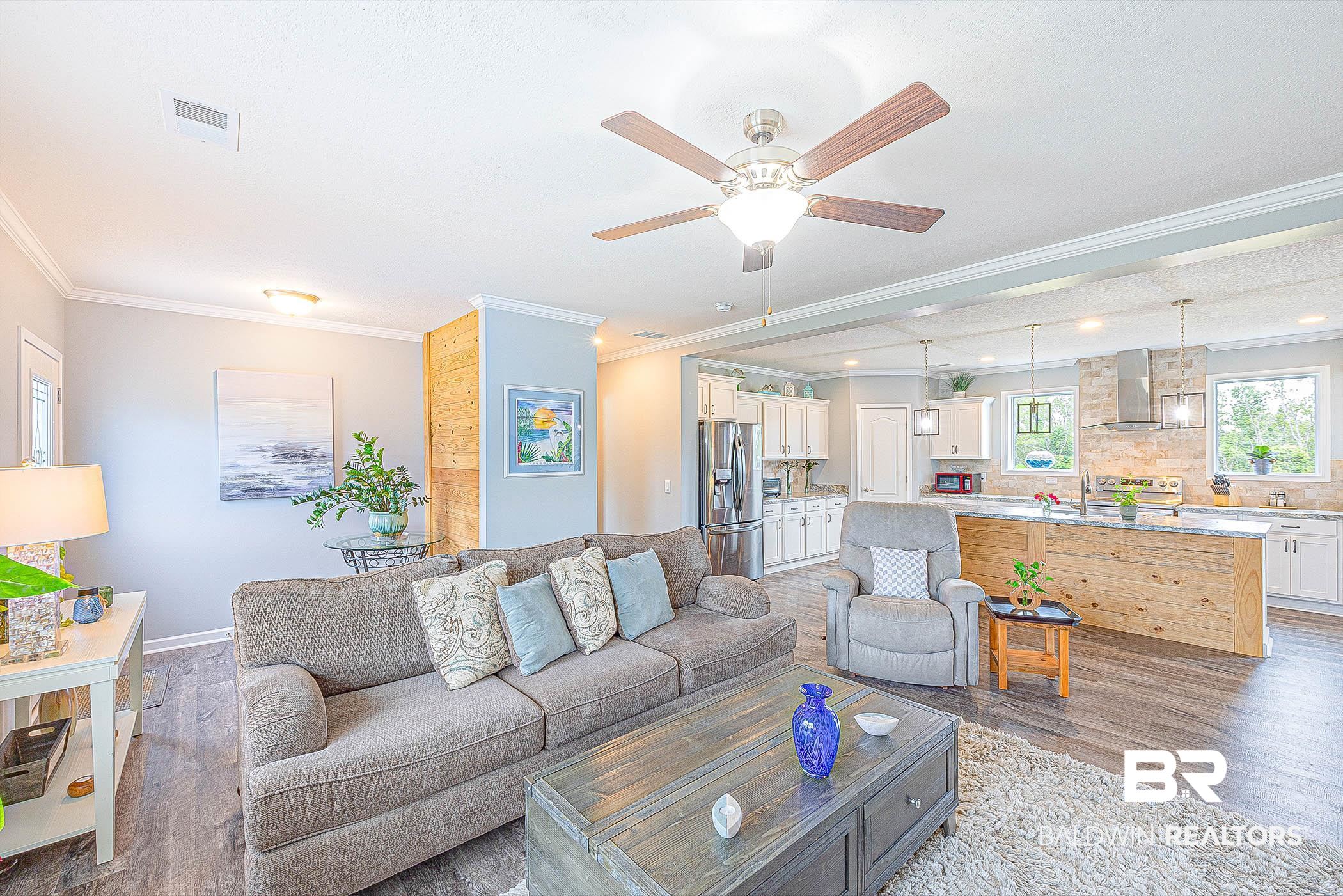 16000 John Bauer Road Summerdale, AL 36580 - Photo 11 of 34 Living room with ornamental molding, visible vents, ceiling fan, and light wood finished floors