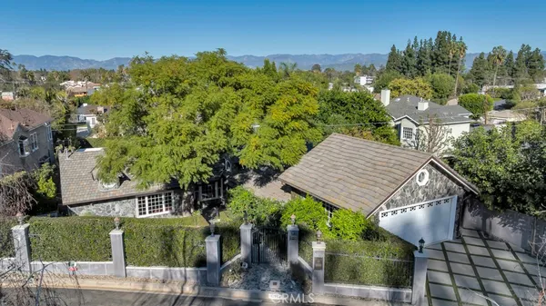 an aerial view of a house with garden space and sitting area