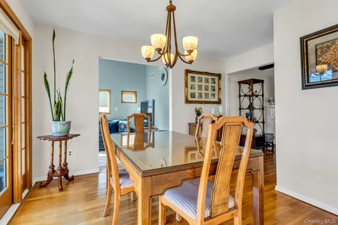 a view of a dining room with furniture and a chandelier