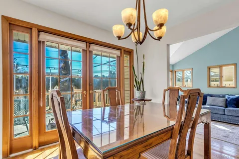 a view of a dining room with furniture wooden floor and chandelier