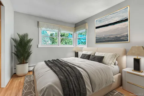 a bedroom with a bed and a painting on the wall