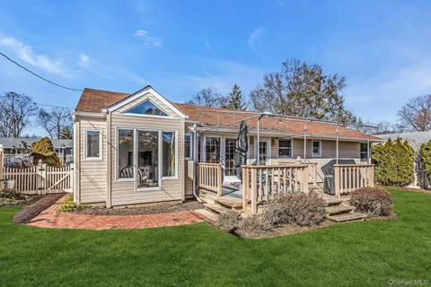 a front view of a house with a yard table and chairs