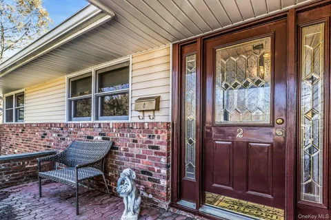 a view of a porch with furniture and next to a window