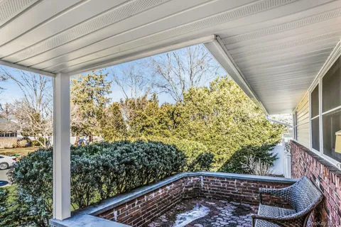 a view of a chair and table in the balcony