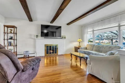 a living room with furniture fireplace and flat screen tv