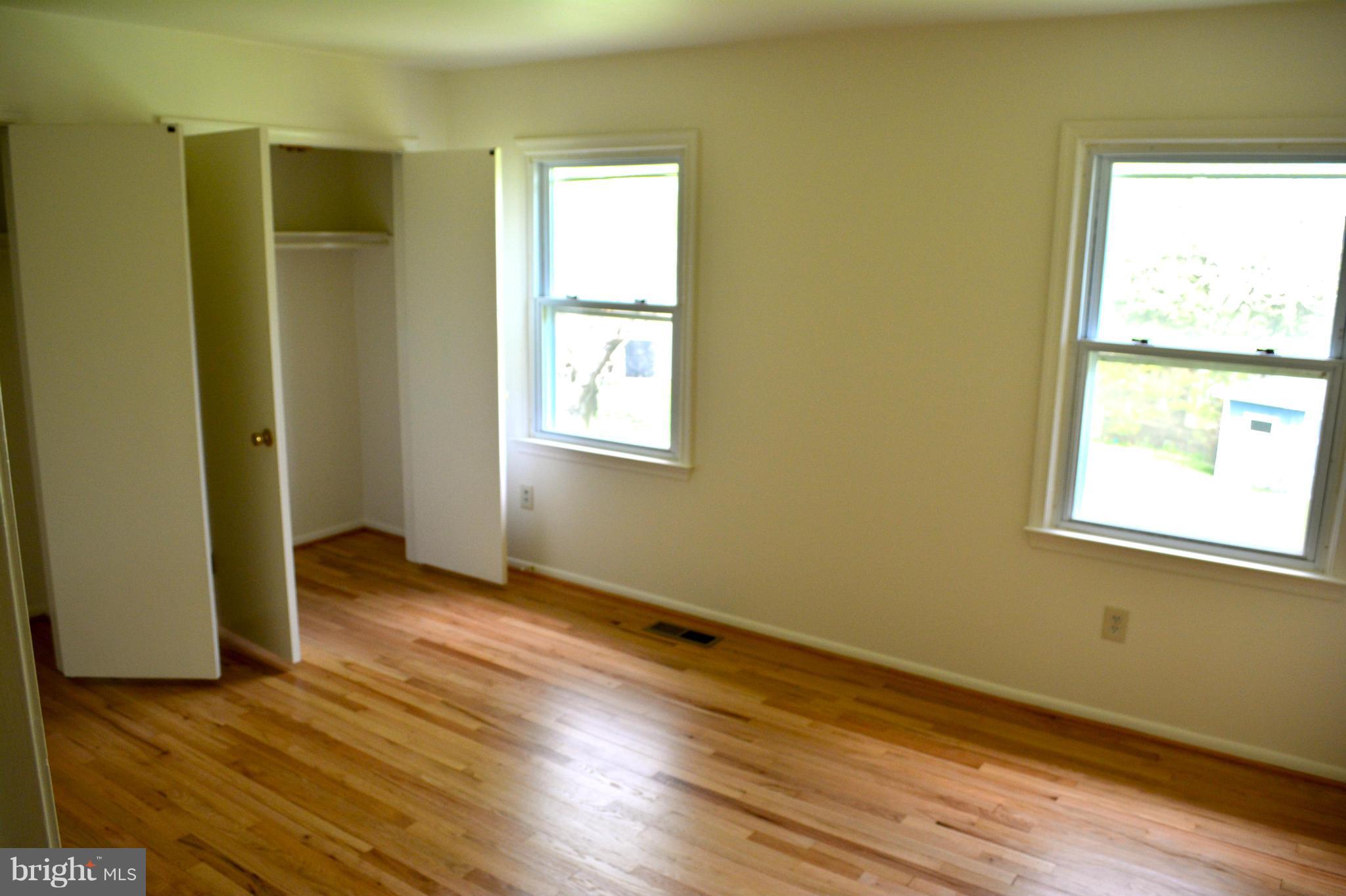 19456 Olney Mill Road Olney, MD 20832 - Photo 14 of 30 a view of an empty room with wooden floor and a window