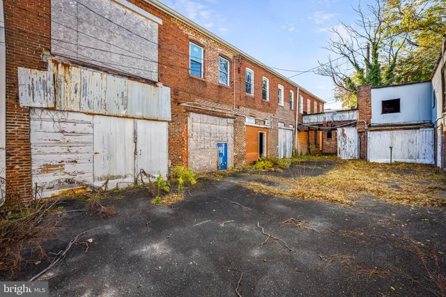 a view of a patio with table and chairs