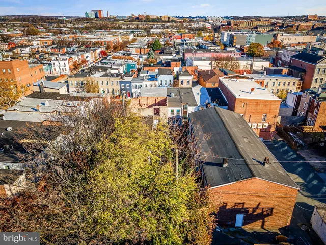 an aerial view of a building with parking