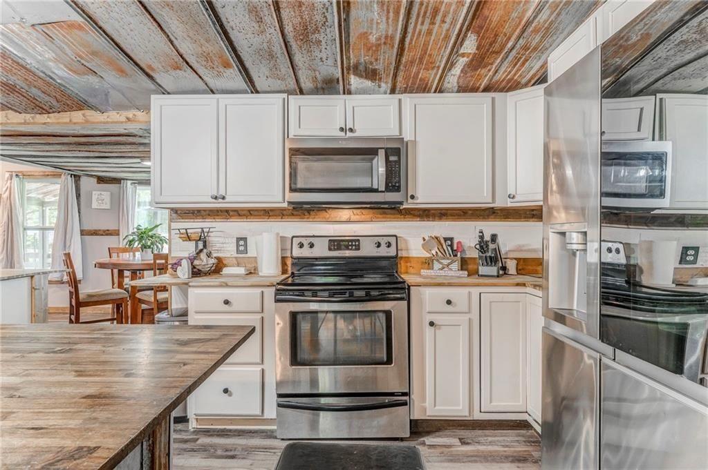 135 Little Creek Lane Resaca, GA 30735 - Photo 15 of 49 a kitchen with stainless steel appliances granite countertop a stove a sink and a microwave