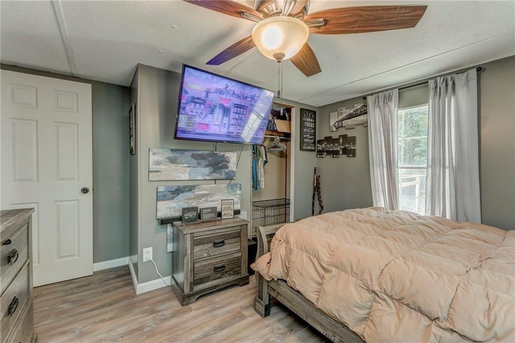 135 Little Creek Lane Resaca, GA 30735 - Photo 34 of 49 a bedroom with a bed and a flat screen tv