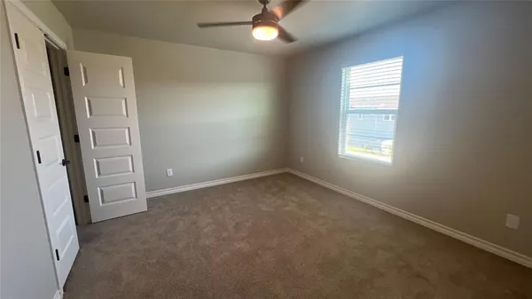 an empty room with windows and entrance