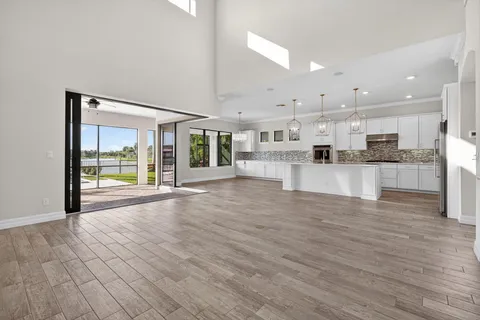 a view of a kitchen with wooden floor and a kitchen