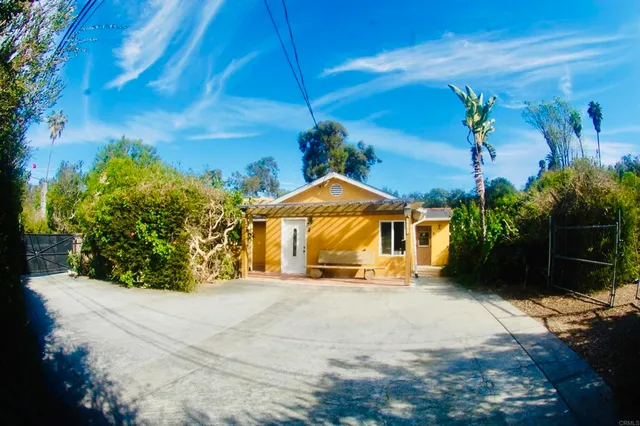 a white toilet sitting next to a bathroom and a shower