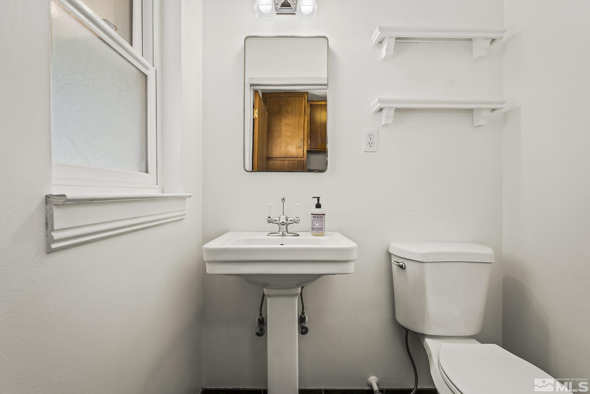 1165 Mt Rose Street Reno, NV 89509 - Photo 11 of 12 a bathroom with a toilet a sink and mirror
