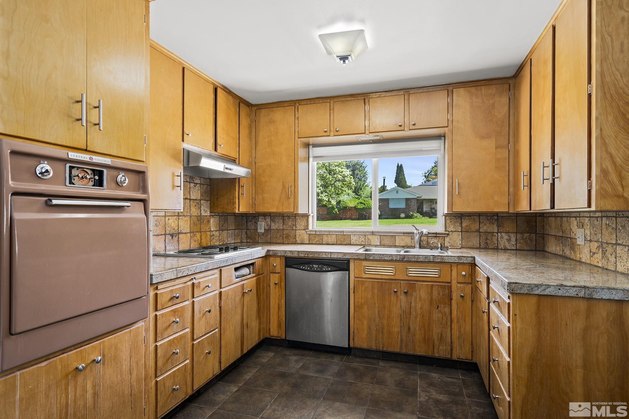 1165 Mt Rose Street Reno, NV 89509 - Photo 5 of 12 a kitchen that has a sink and a stove in it