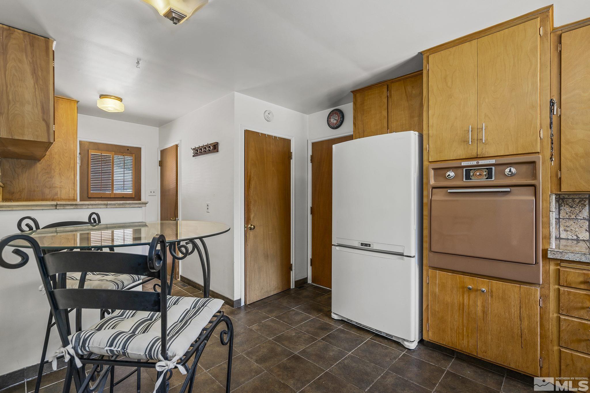 1165 Mt Rose Street Reno, NV 89509 - Photo 6 of 12 a white refrigerator freezer and a table in a kitchen