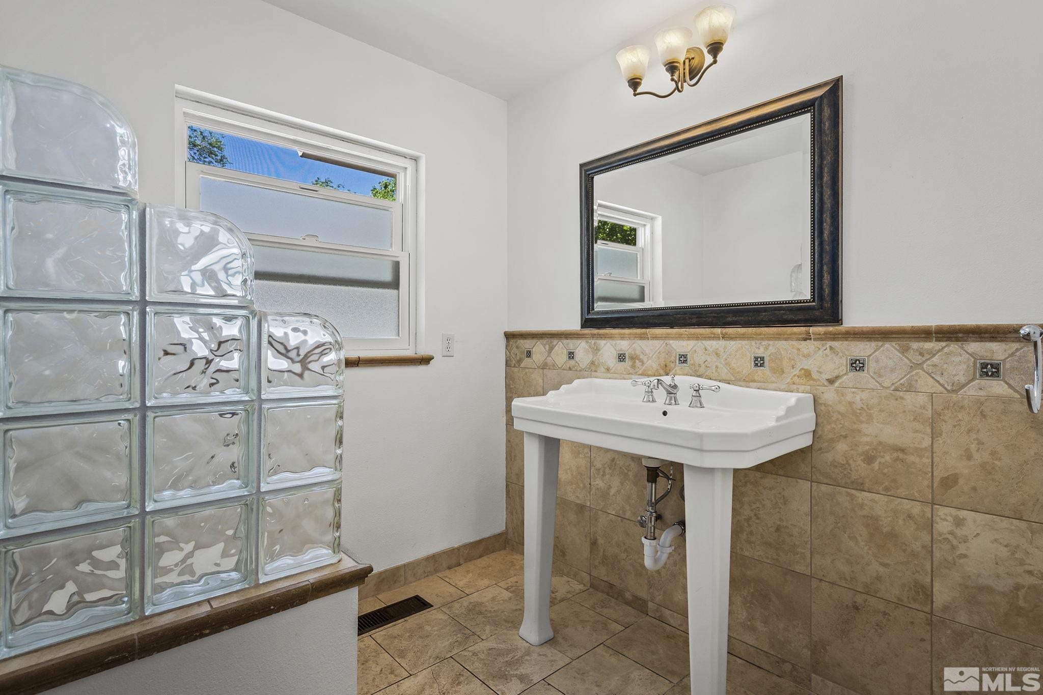 1165 Mt Rose Street Reno, NV 89509 - Photo 9 of 12 a bathroom with a sink and a mirror