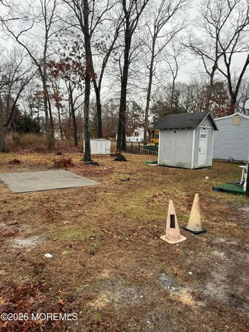 a view of a fire pit with large trees