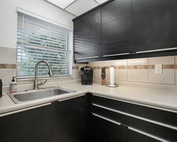 a kitchen with a sink and cabinets