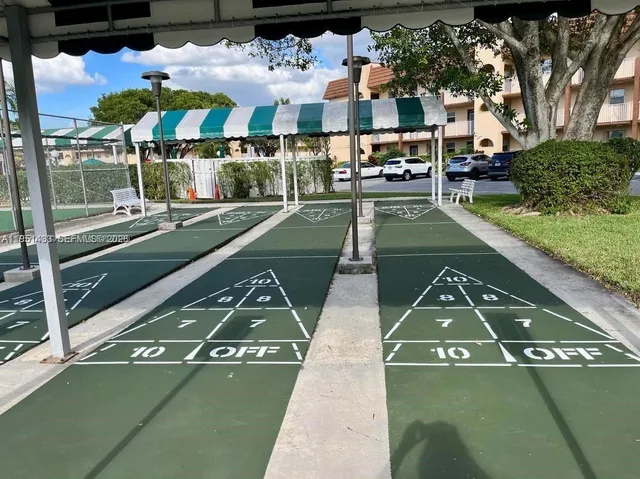 a view of a patio with chairs and a fireplace