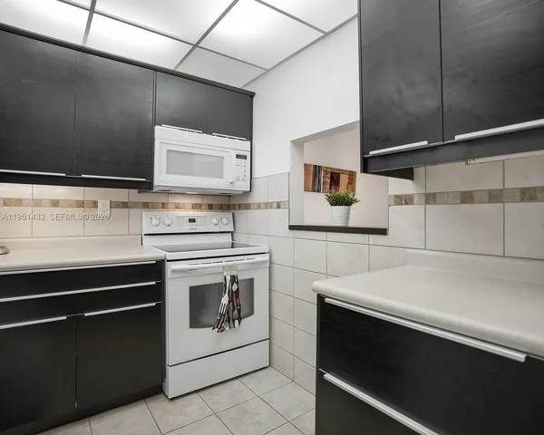 a kitchen with stainless steel appliances a stove and a microwave