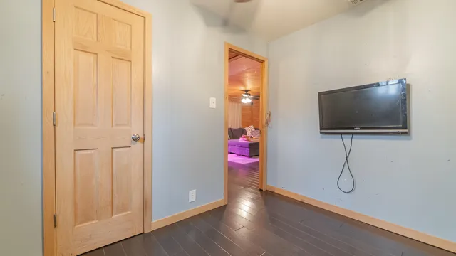 a view of a livingroom with wooden floor and cabinet