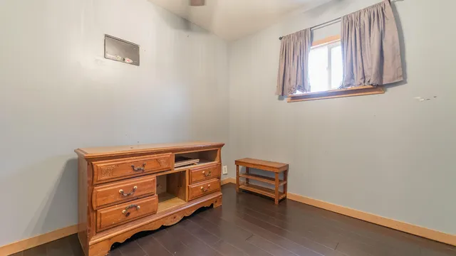 a view of room with wooden floor and cabinet