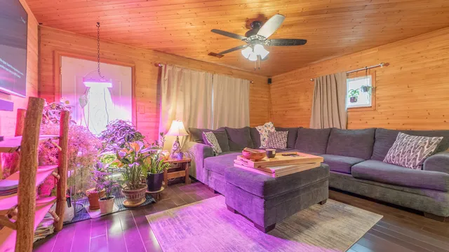 a living room with furniture and wooden floor