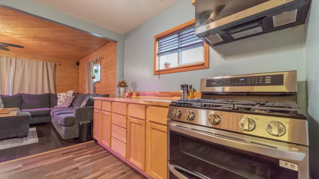 a kitchen with stainless steel appliances a stove a sink and cabinets