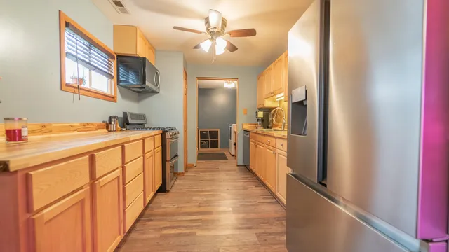 a view of a kitchen with a sink and a refrigerator