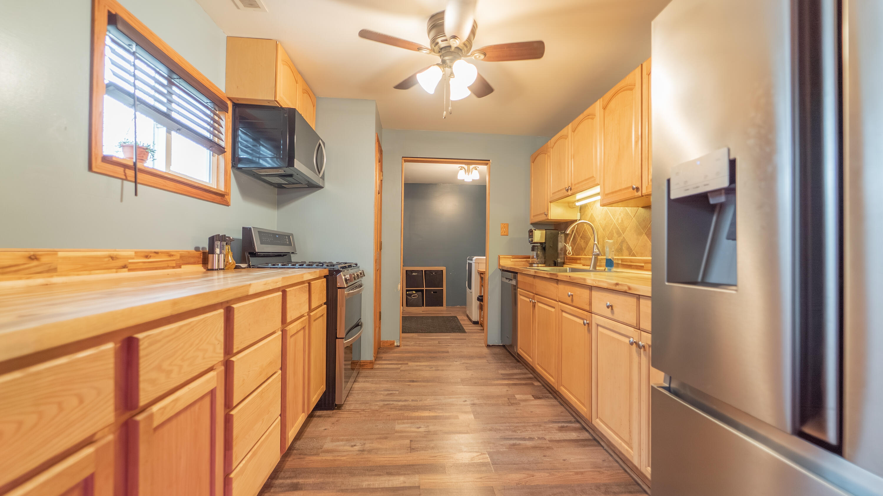3161 Pulaski Street Hobart, IN 46342 - Photo 10 of 22 a kitchen with stainless steel appliances a sink dishwasher a refrigerator with wooden floor and cabinets