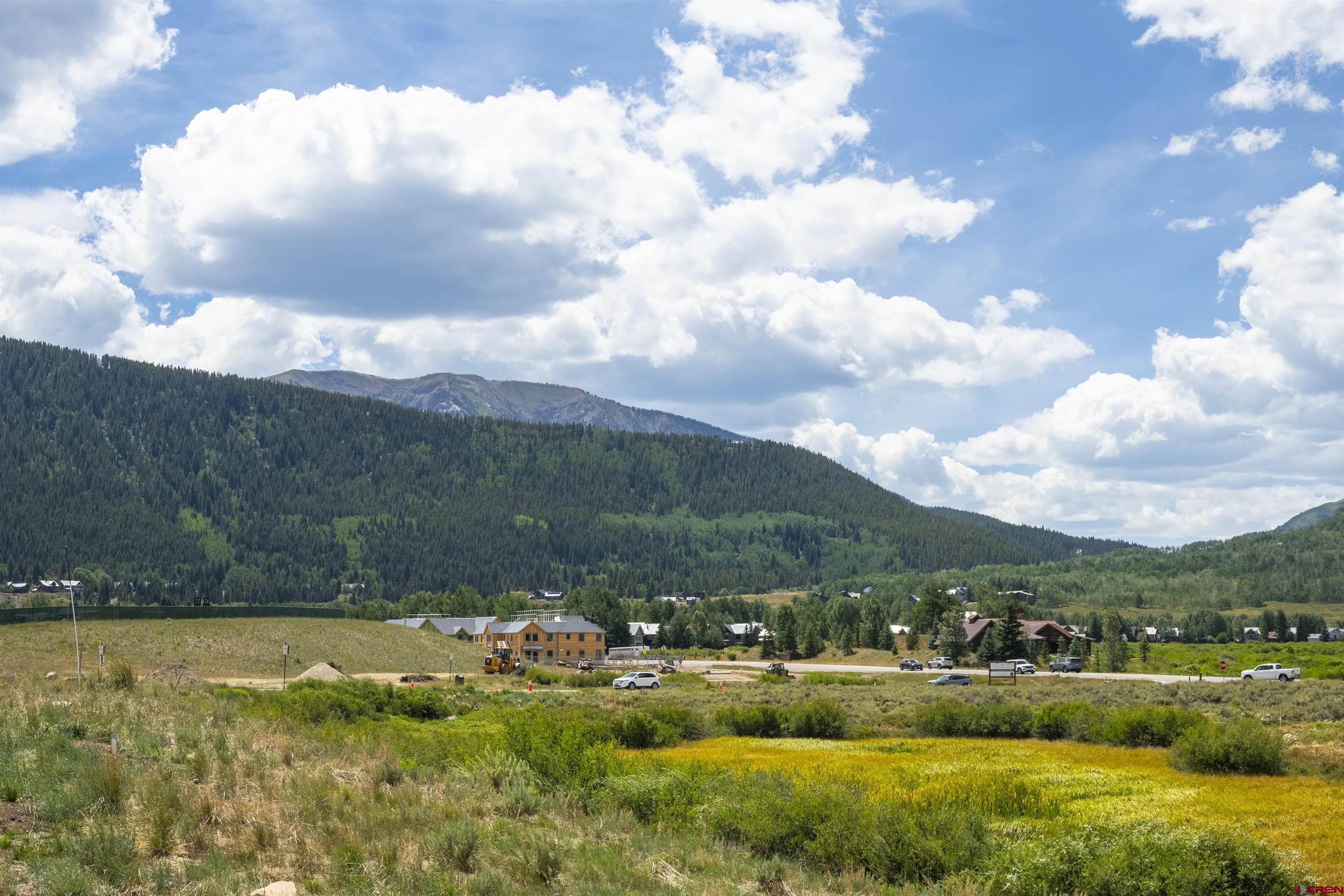 55 Pyramid Avenue Crested Butte, CO 81224 - Photo 26 of 35 a view of a lake with houses in the back