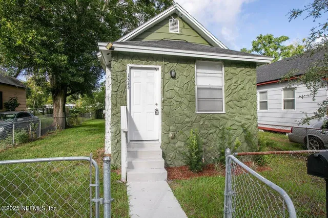 a front view of a house with garden