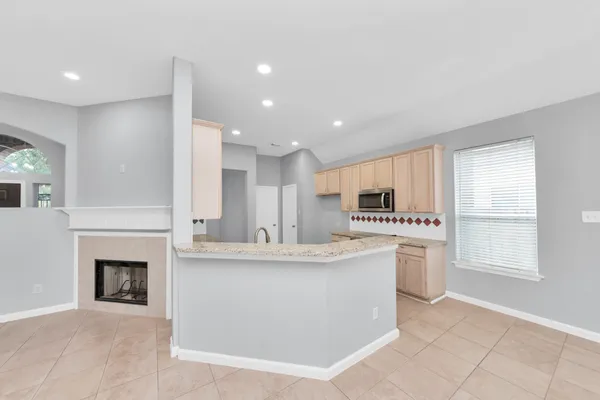 a view of kitchen with sink and microwave