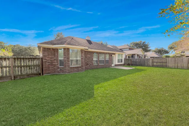 a view of a house with a yard and sitting area