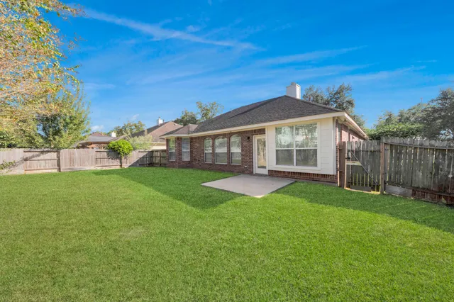 a view of a house with a yard and sitting area