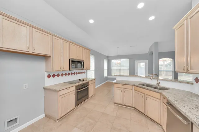 a kitchen with a sink and white cabinets
