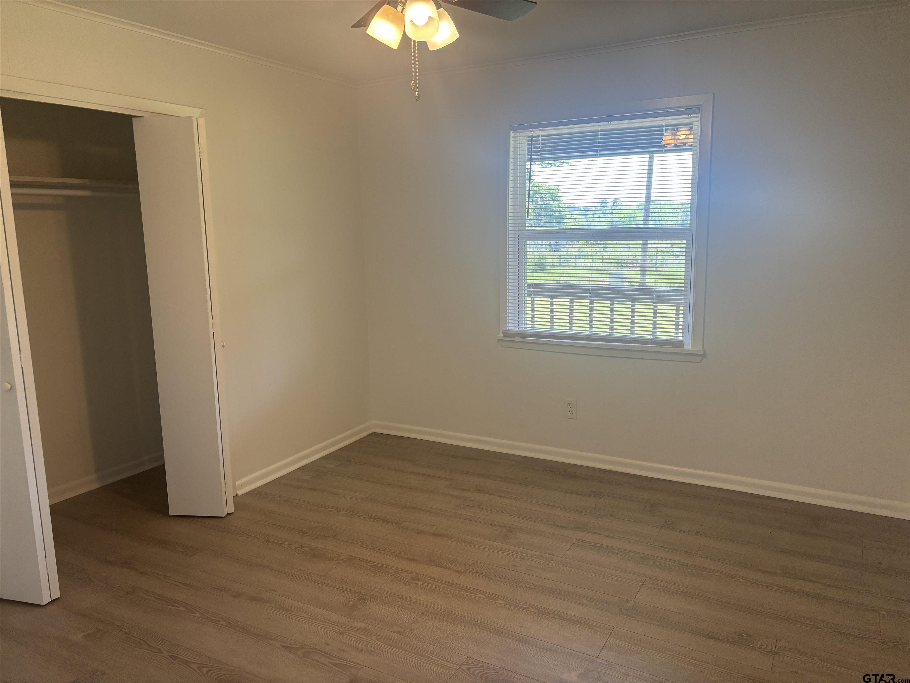 6282 Fm 2245 Pittsburg, TX 75686 - Photo 11 of 13 an empty room with wooden floor and windows