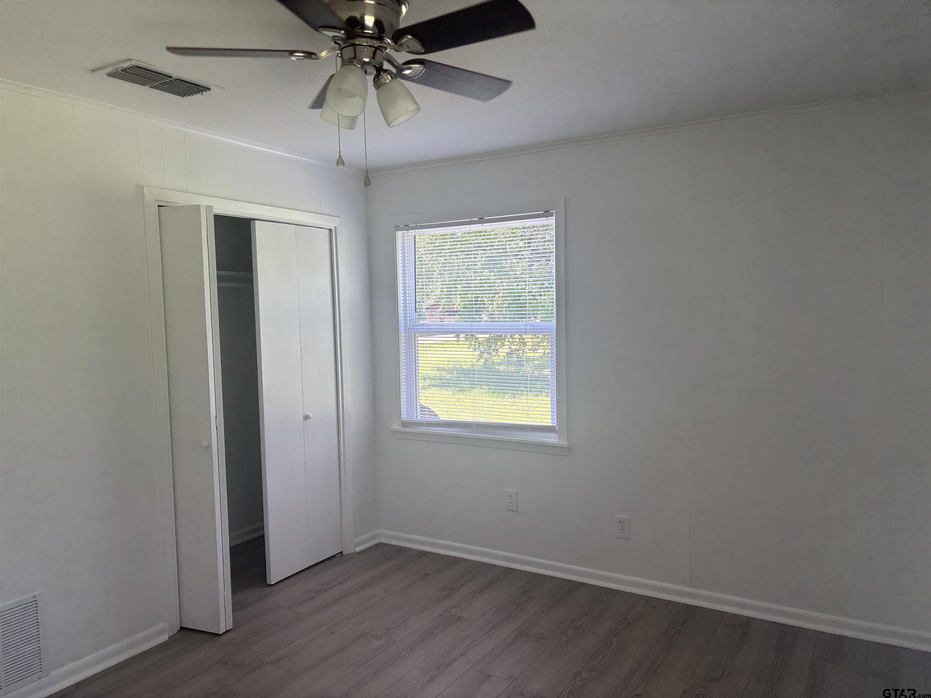 6282 Fm 2245 Pittsburg, TX 75686 - Photo 12 of 13 an empty room with a window and a ceiling fan