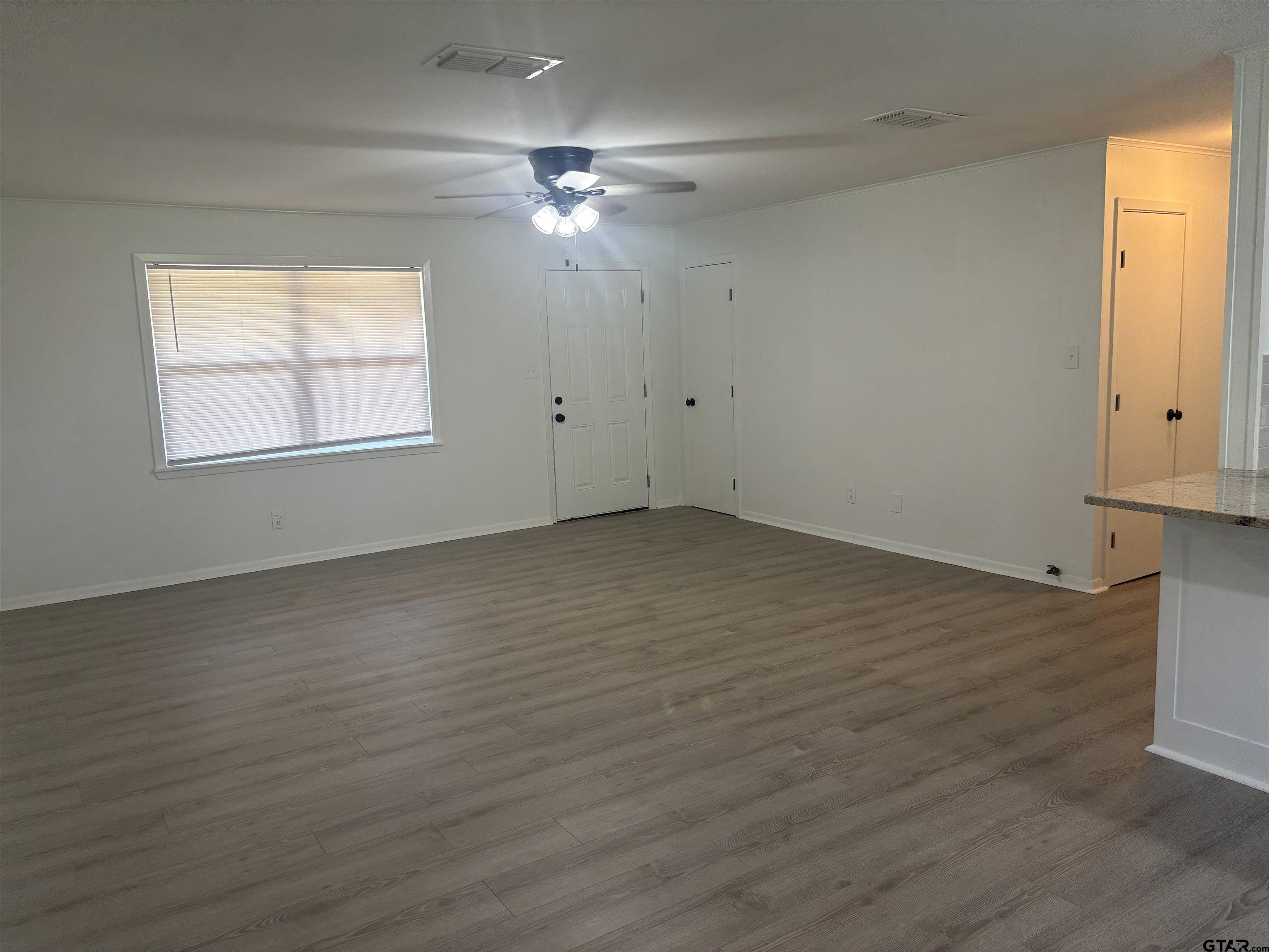 6282 Fm 2245 Pittsburg, TX 75686 - Photo 3 of 13 a view of an empty room with wooden floor and a window