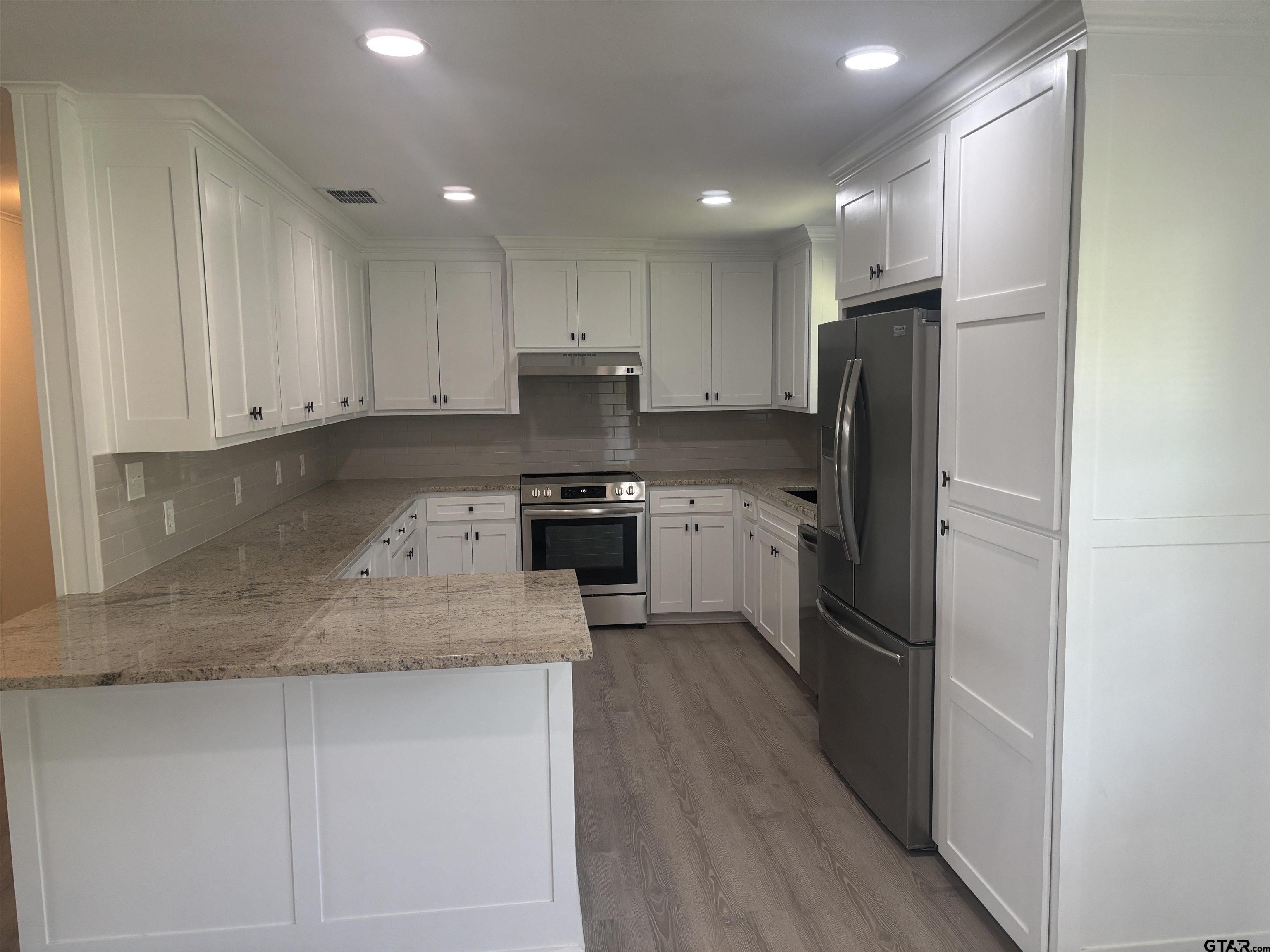 6282 Fm 2245 Pittsburg, TX 75686 - Photo 6 of 13 a kitchen with a refrigerator a sink and a stove