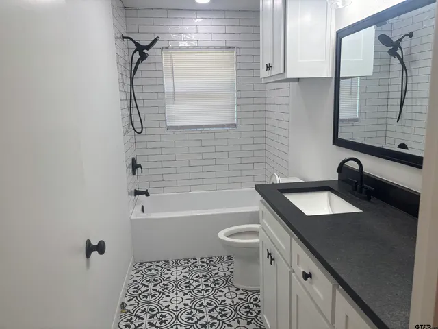 a bathroom with a sink toilet tub and shower