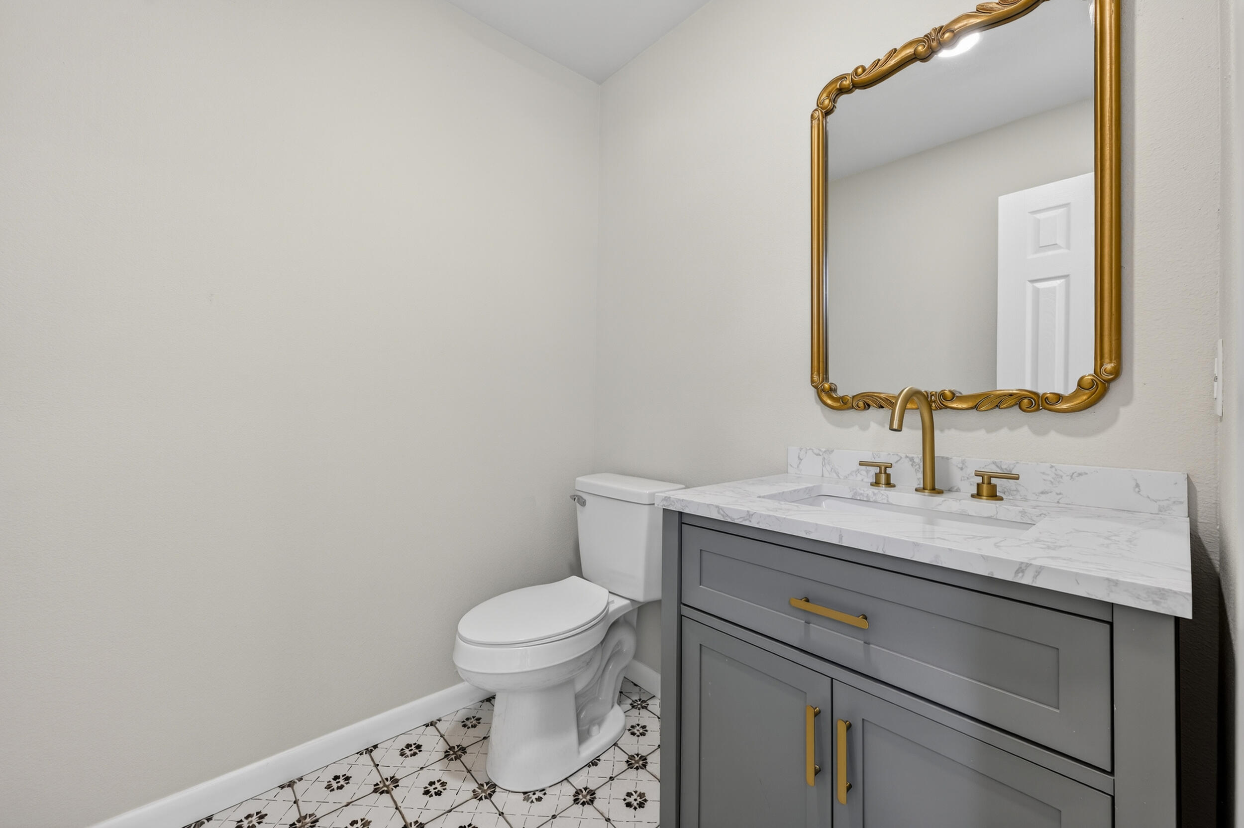 758 9th Avenue Crestview, FL 32536 - Photo 25 of 55 a bathroom with a granite countertop toilet sink and mirror