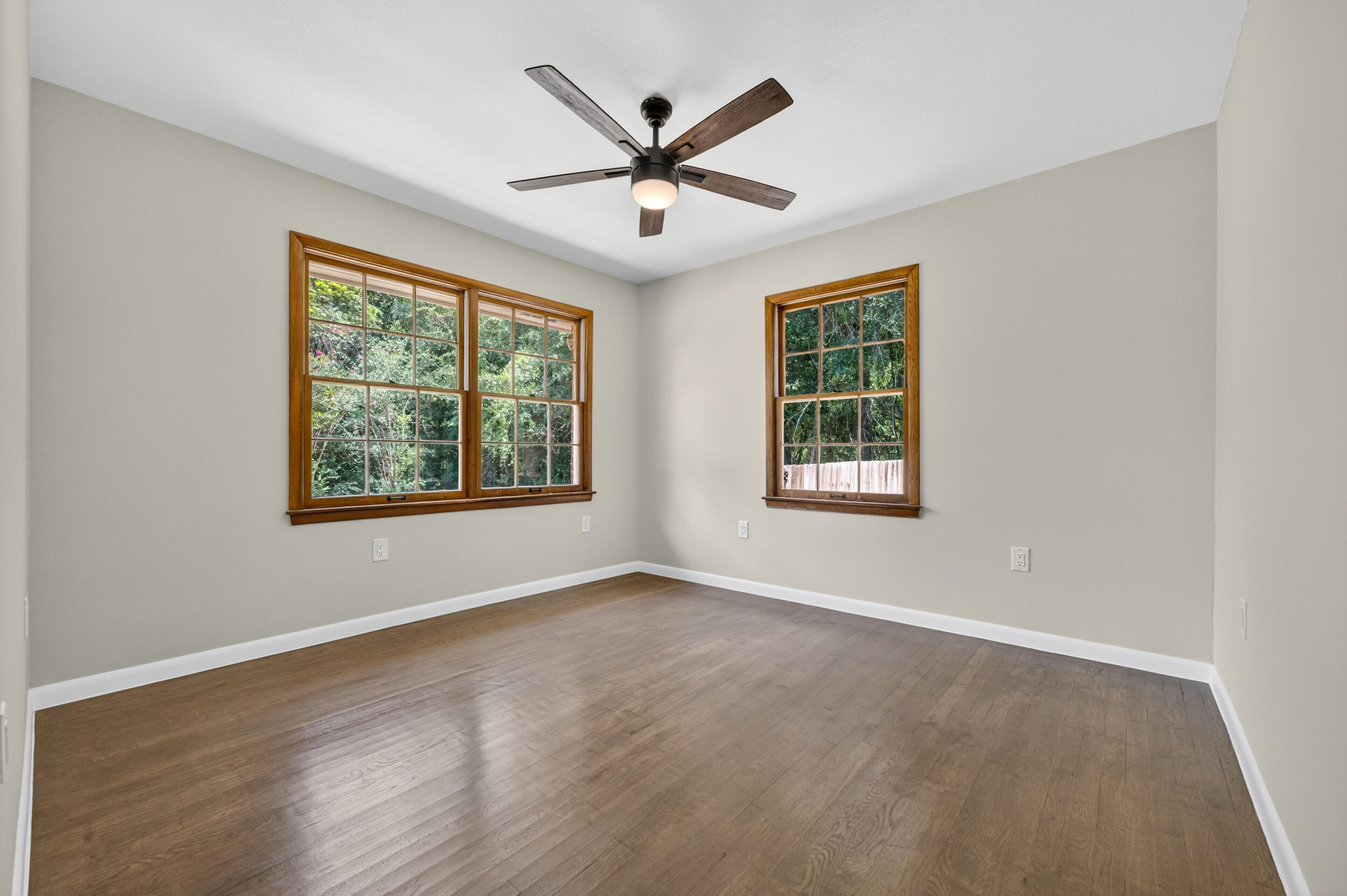 758 9th Avenue Crestview, FL 32536 - Photo 26 of 55 a view of an empty room with wooden floor and a window
