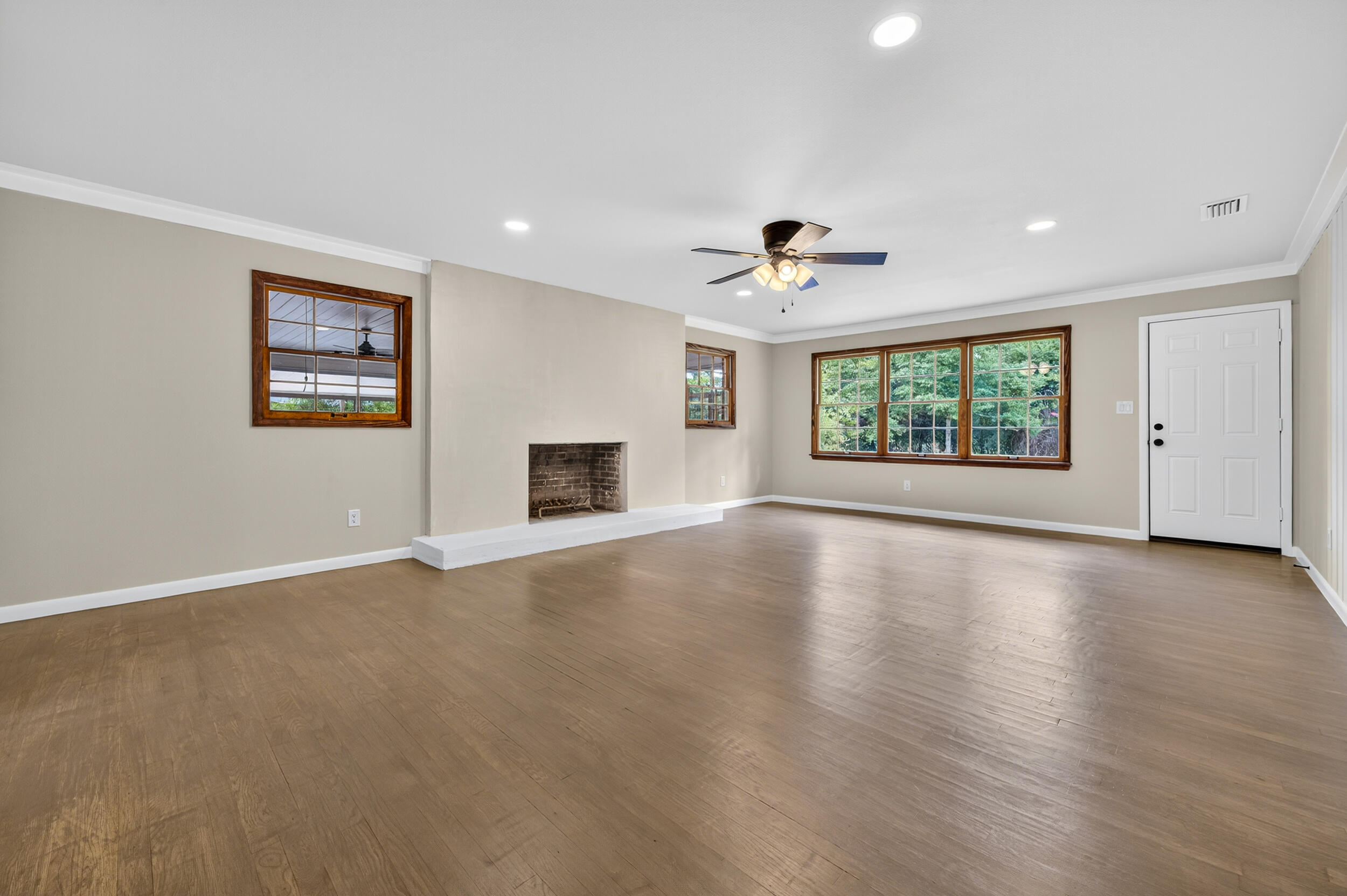 758 9th Avenue Crestview, FL 32536 - Photo 8 of 55 a view of an empty room with a window and wooden floor