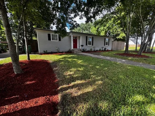 a front view of house with yard and trees