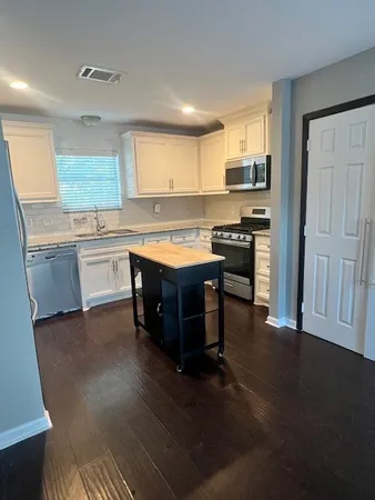 a kitchen with stainless steel appliances granite countertop a stove a sink dishwasher and a refrigerator